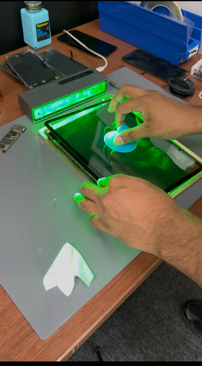 Aligning the new replacement glass to the iPad display in a jig