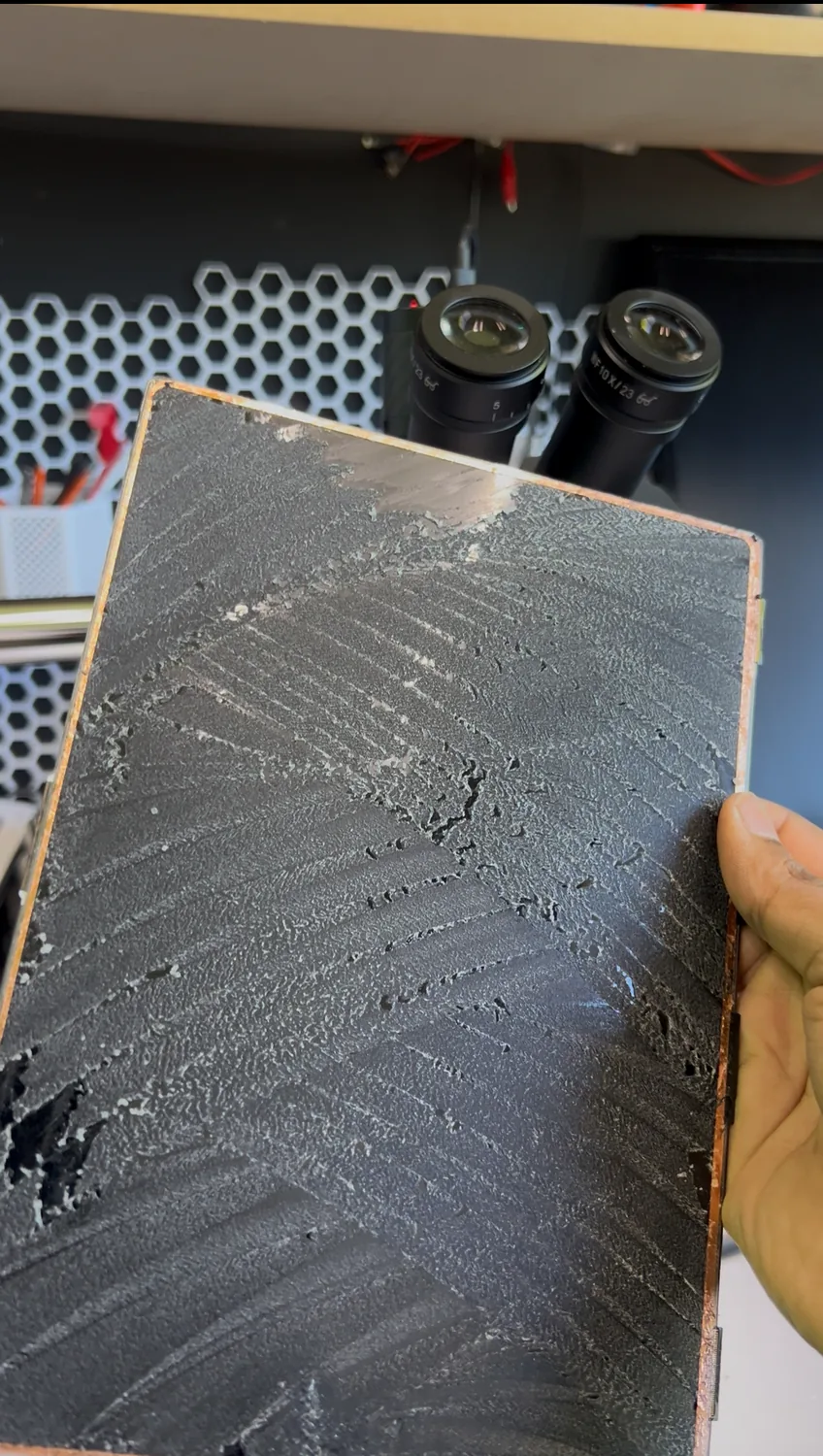 The cracked glass removed from the iPad display, with the OCA adhesive layer left behind