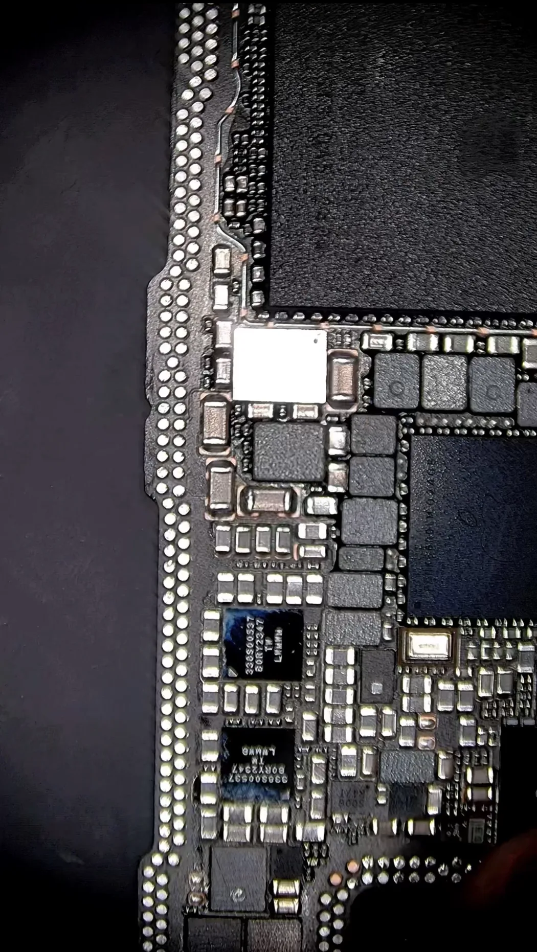 iPhone 15 Pro Max logic board removed and under the microscope