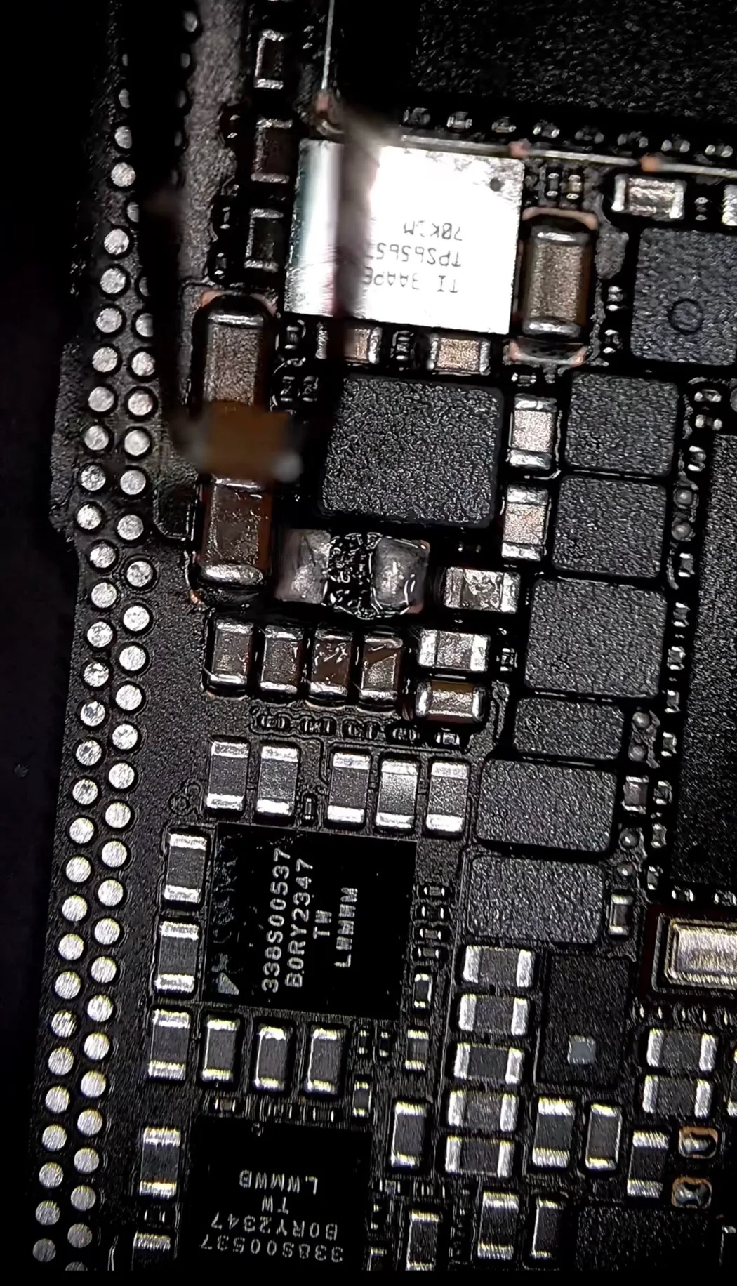 The failed capacitor removed, pads cleaned and ready for the replacement