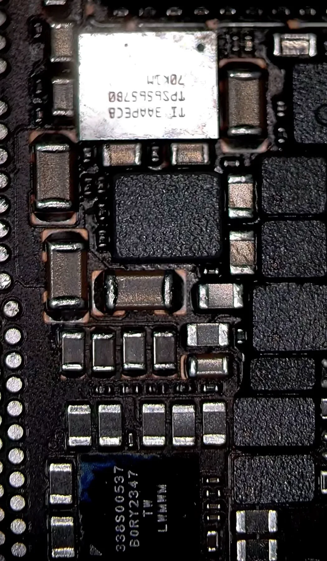 Microscope close-up of the display power section beside the TPS65657 PMIC
