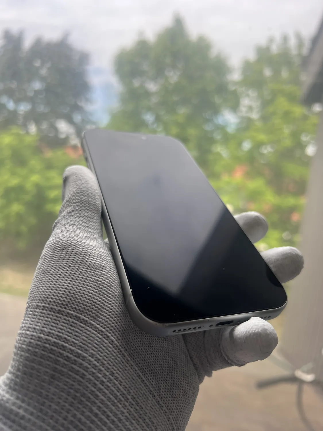 Technician handling an iPhone with anti-static gloves after a glass-only screen repair in Mississauga