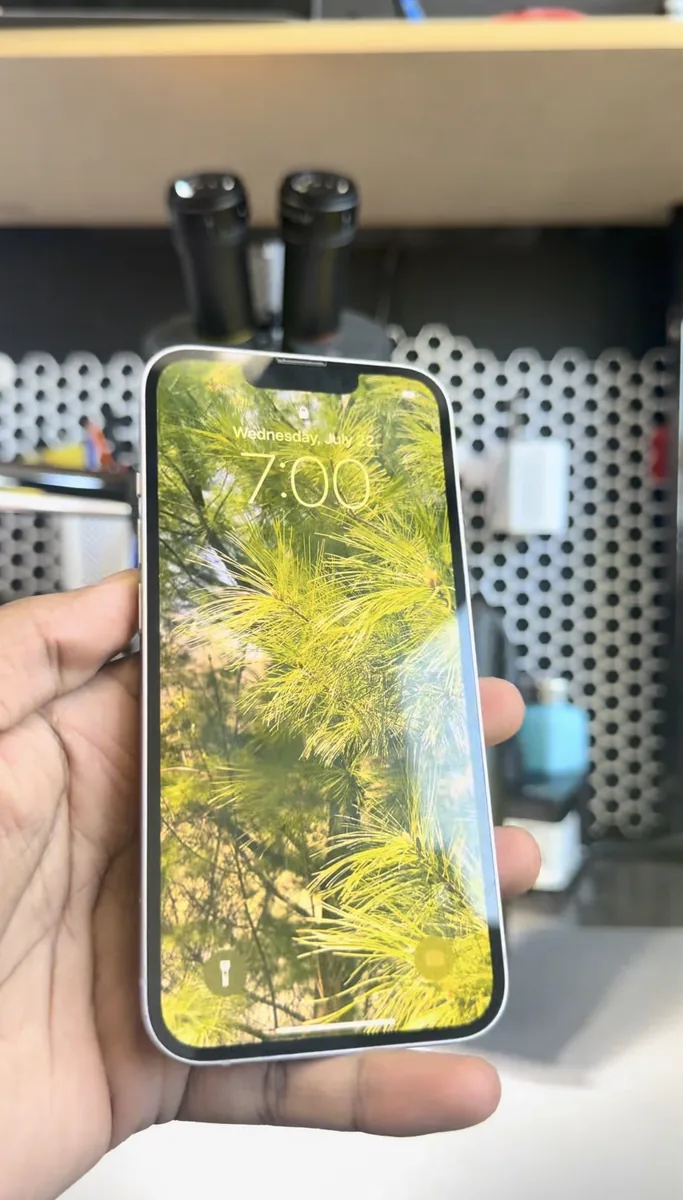 Repaired iPhone 14 powered on and showing the lock screen after power IC replacement