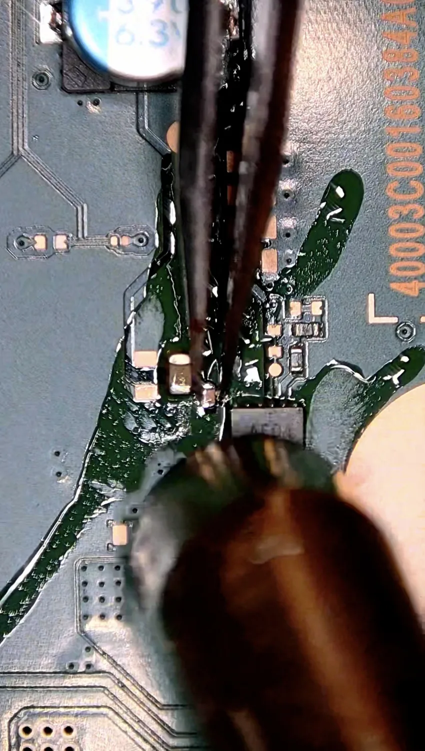 Removing the shorted capacitor from the PS5 board under the microscope
