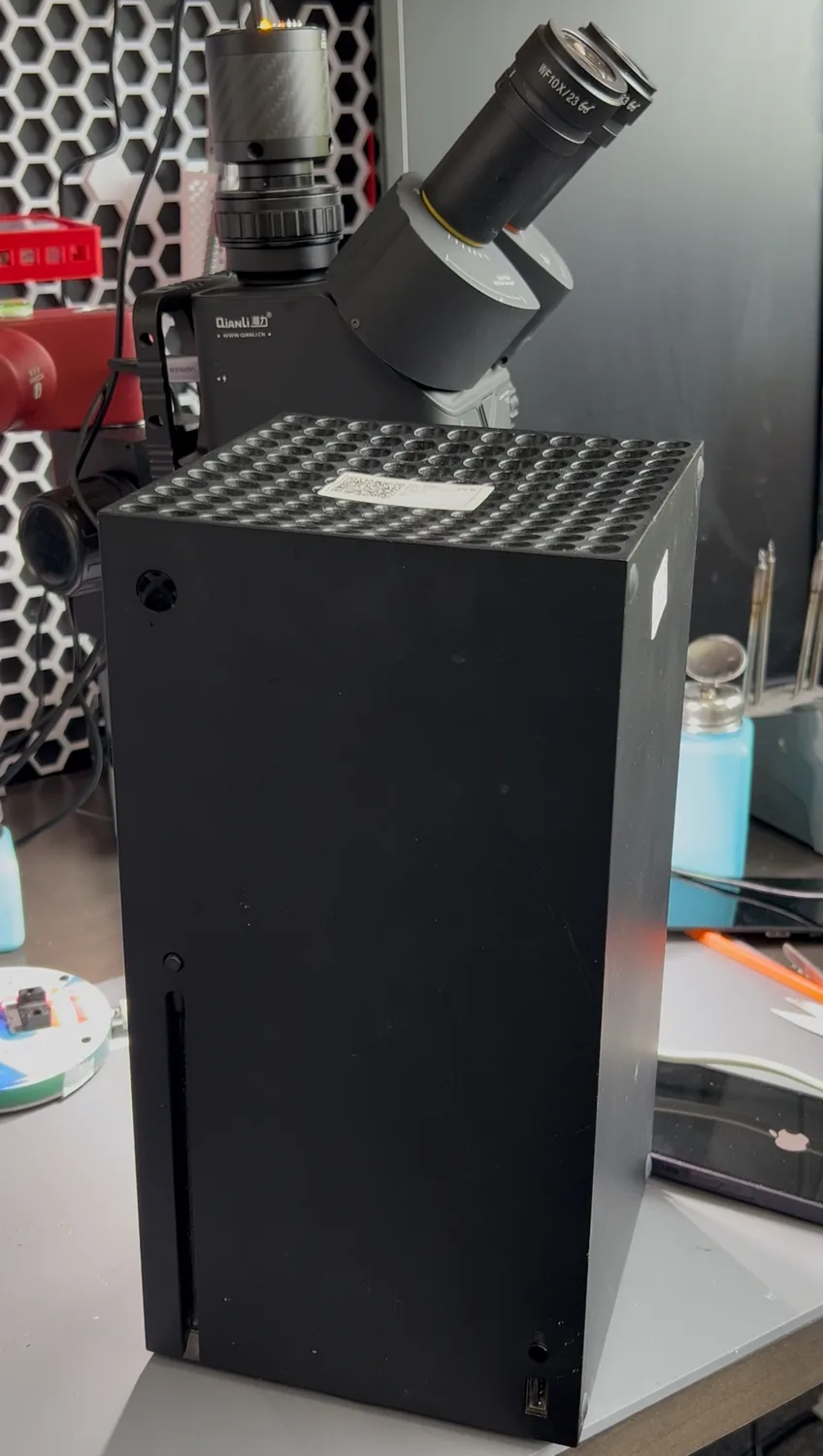 Xbox Series X standing on the Fix It Lads repair bench