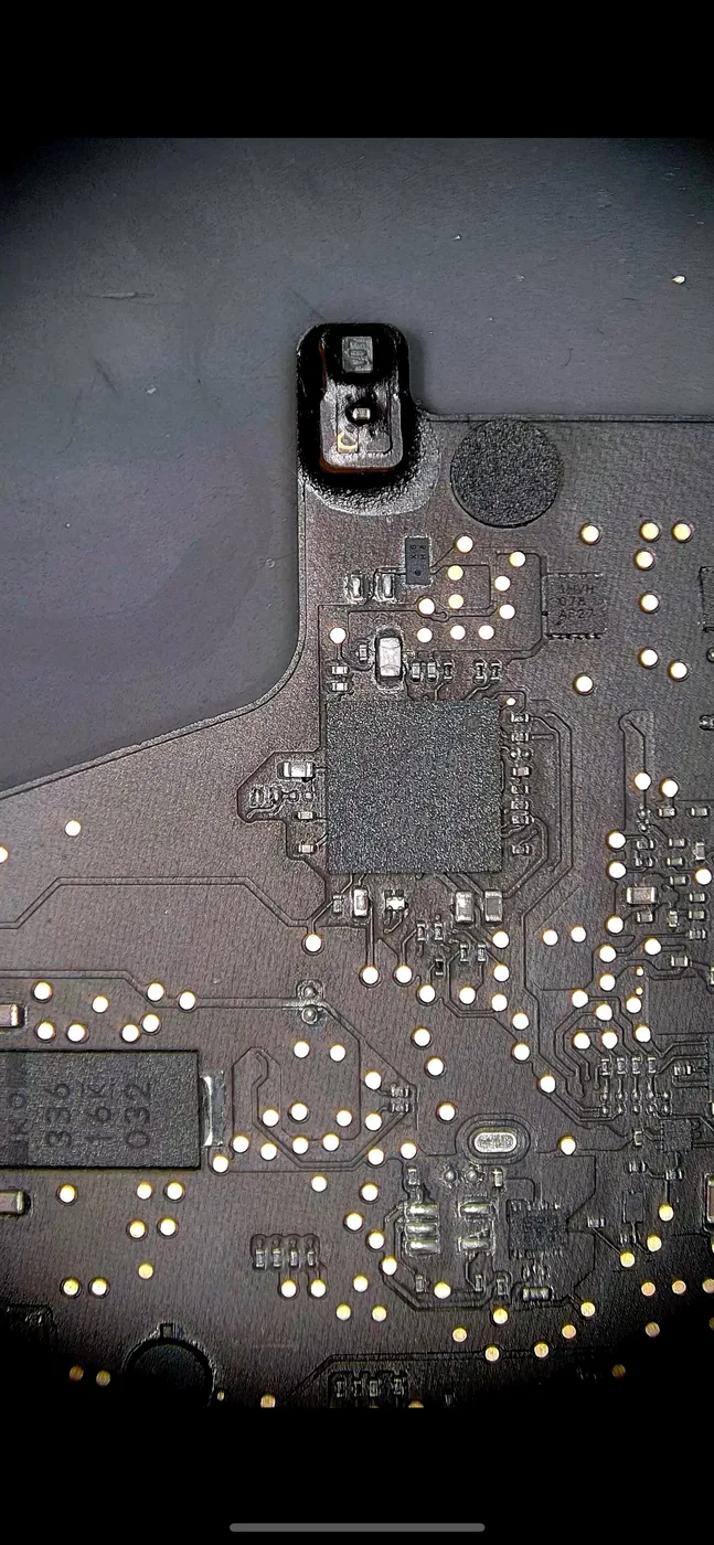 Logic board under a microscope during board-level repair at the Fix It Lads bench